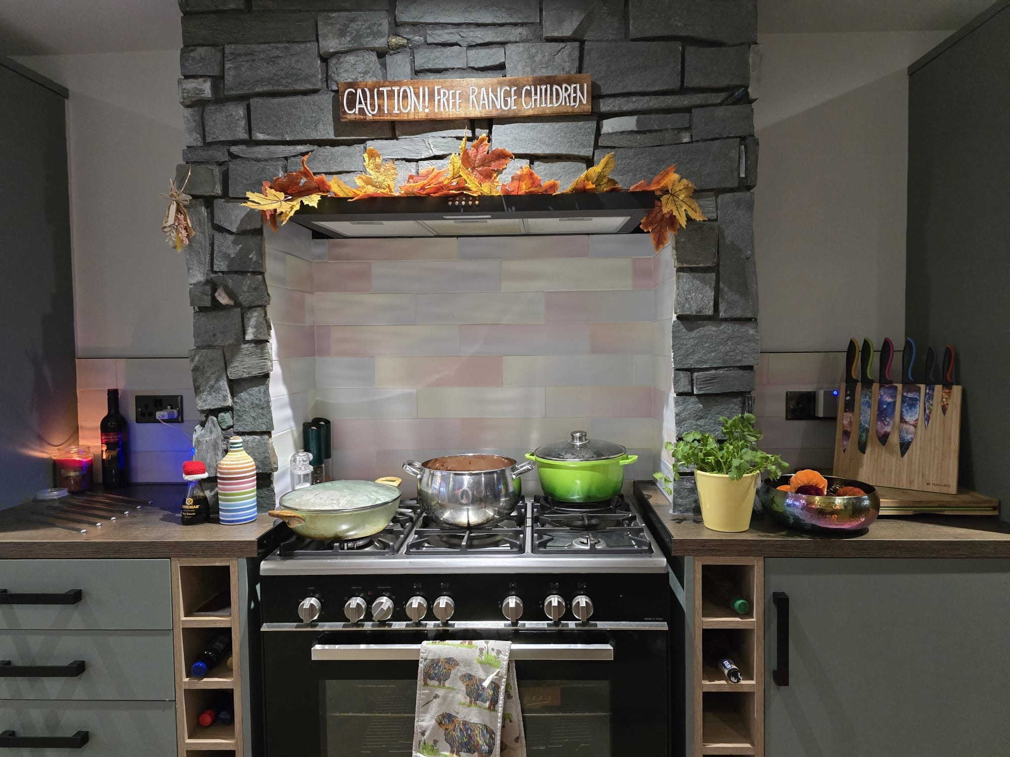 Kitchen stone and tile surround with fitted cabinetry