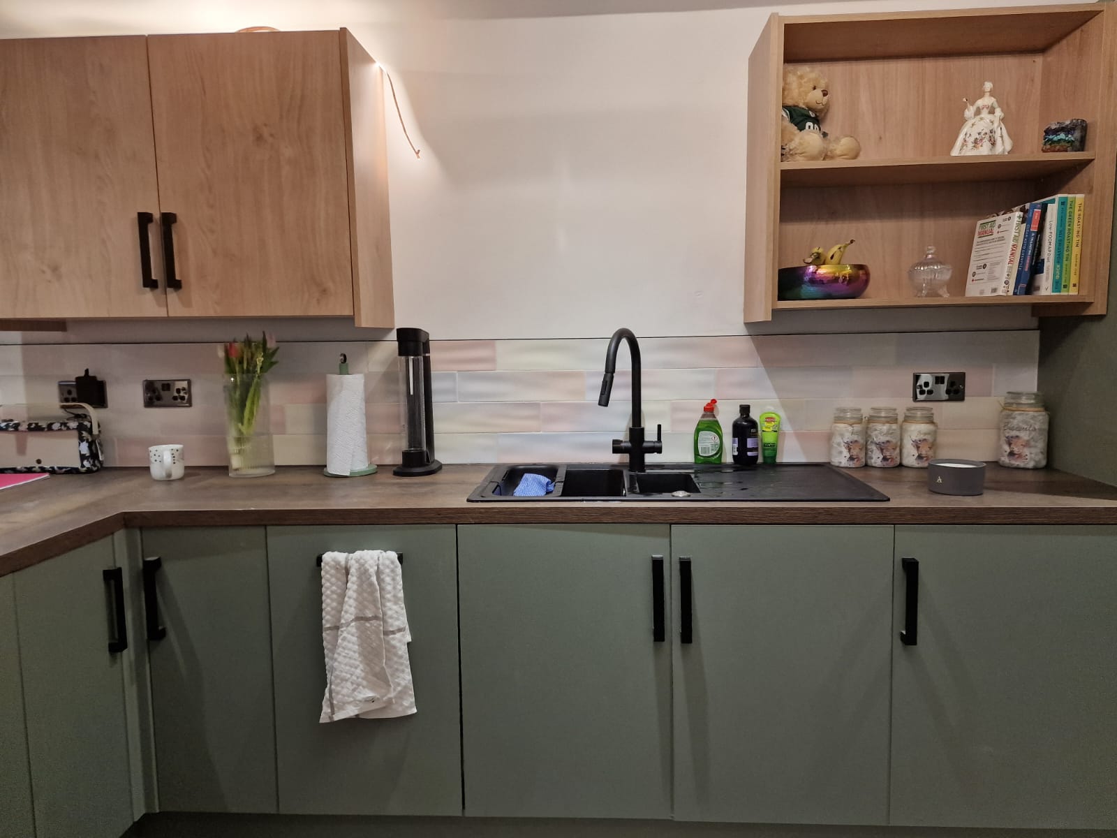 Kitchen sink run with fitted cabinets and timber shelves
