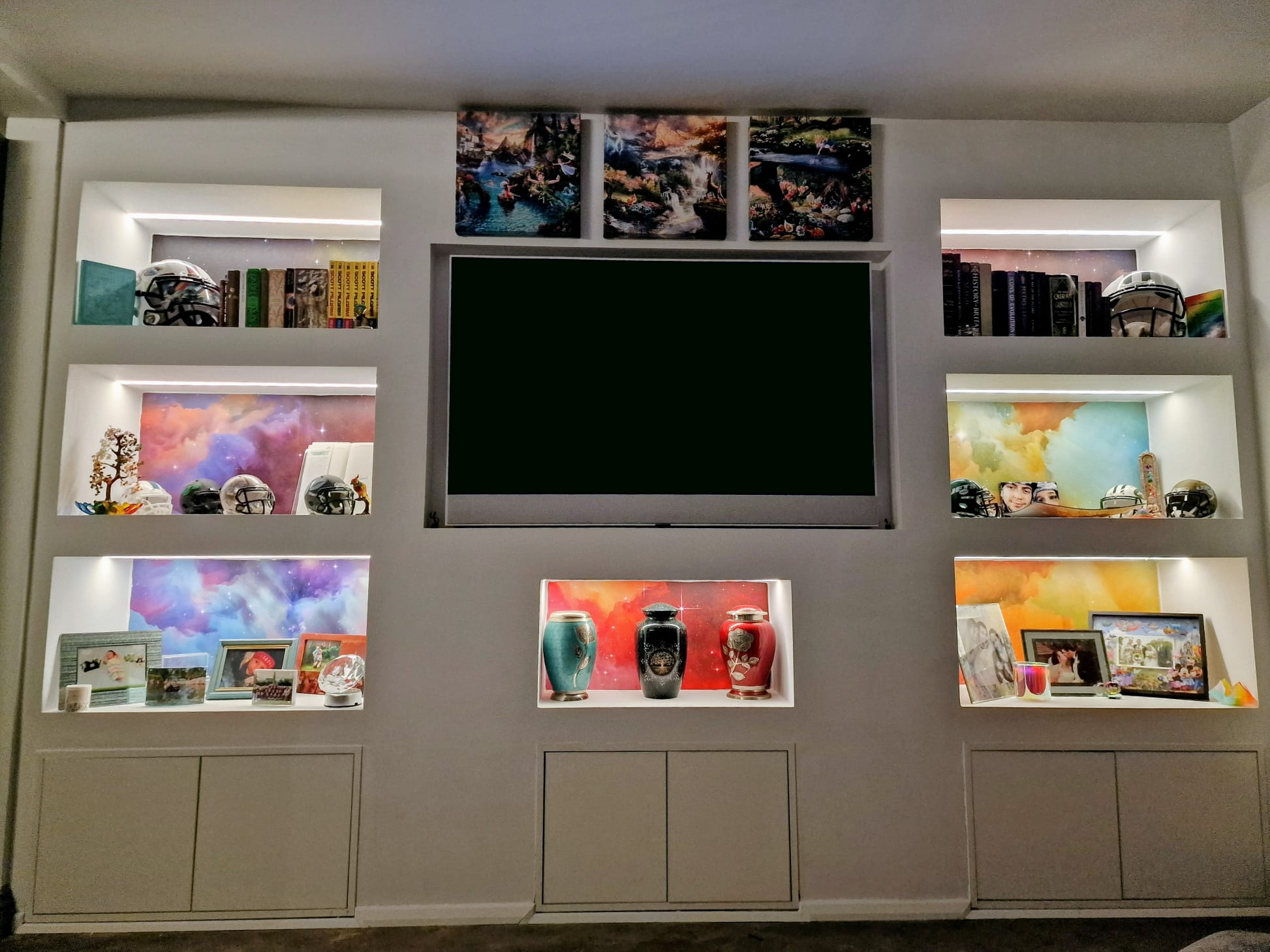 Front view of media wall with lit display shelving
